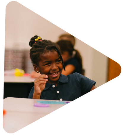 small girl in a dark blue shirt laughing