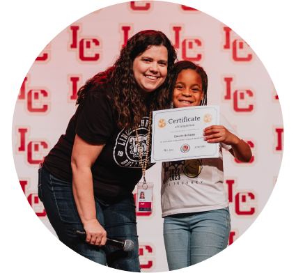 teacher with student earning an award