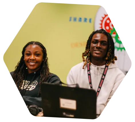 two students with a laptop