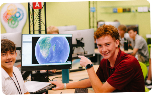 student pointing at a computer